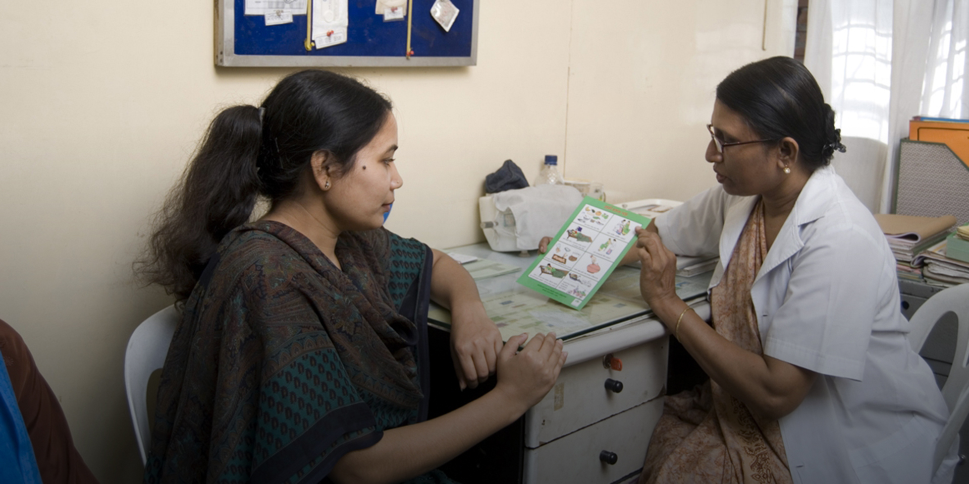 A health worker talks to a patient