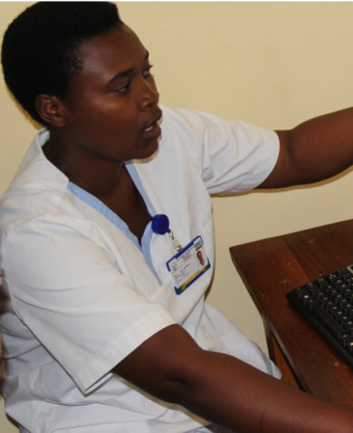Image of a healthcare worker pointing at a computer monitor.