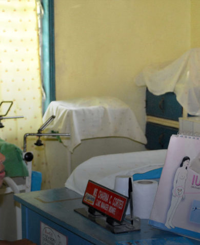 Image of a healthcare professional showing and explaining a family planning device to a young woman.