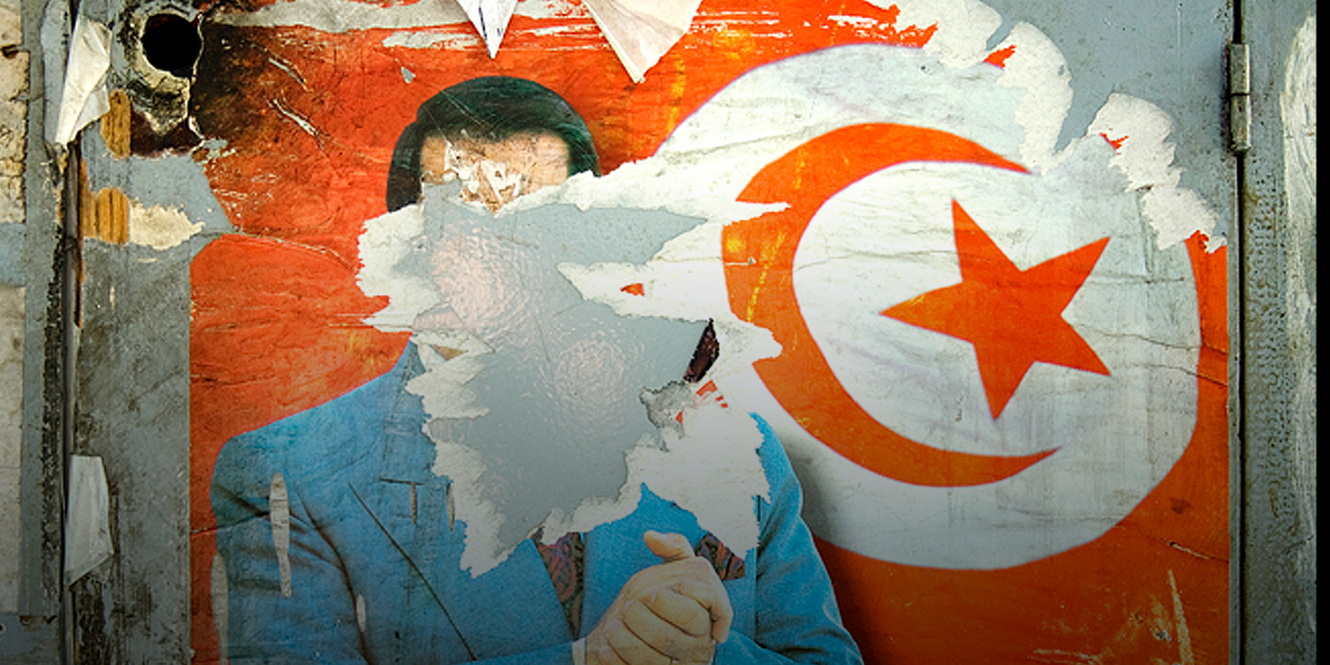 A defaced political mural showing the face of a politician ripped down and the Tunisian flag in the background.