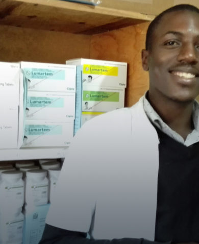 Image of a man in a pharmacy posing with a box of "Lumartem."