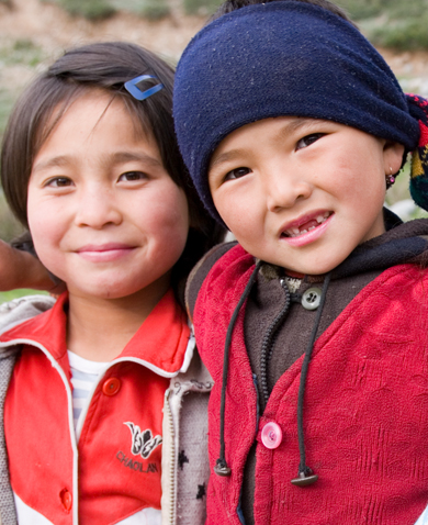 Image of two smiling children posing for a photo.