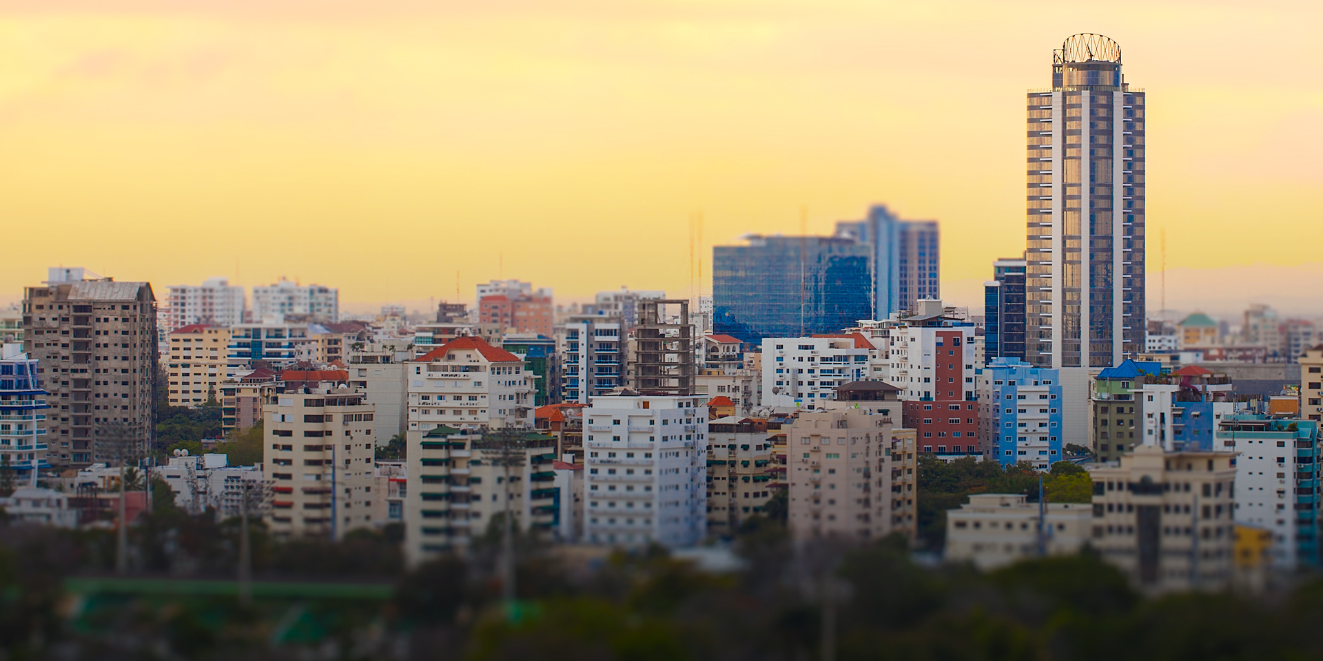 A city skyline with several colorful buildings dotting the landscape.