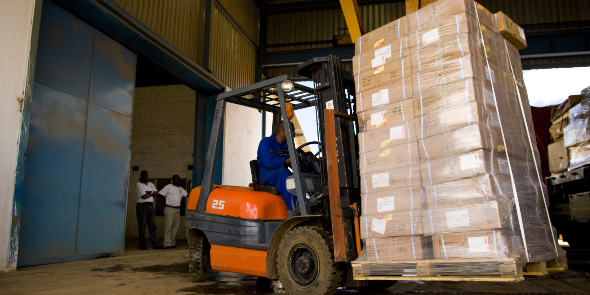 A truck laden with imported goods is unloaded in the Global Logistics Warehouses, Lusaka, Zambia