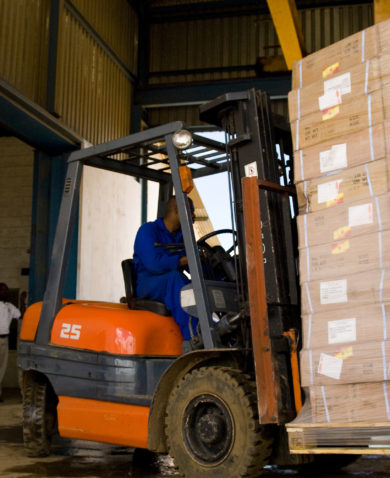 A truck laden with imported goods is unloaded in the Global Logistics Warehouses, Lusaka, Zambia