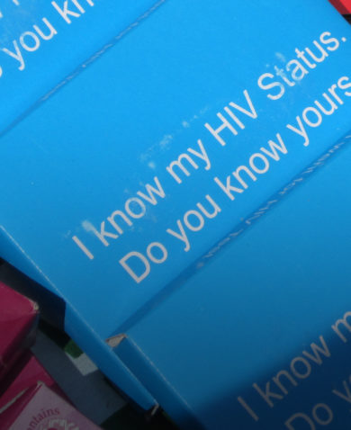 Small boxes displayed on a table, on which are written, "I know my HIV status. Do you know yours?"