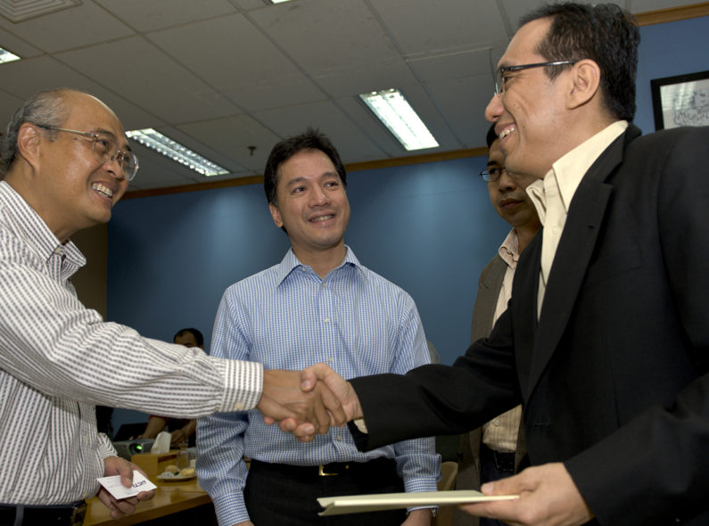 Men shaking hands and smiling