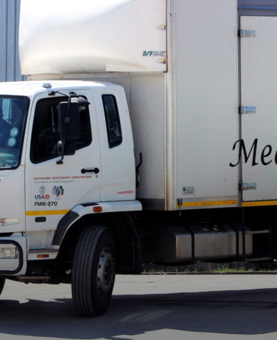 Image of a white truck marked "MSL" driving through an open gate.