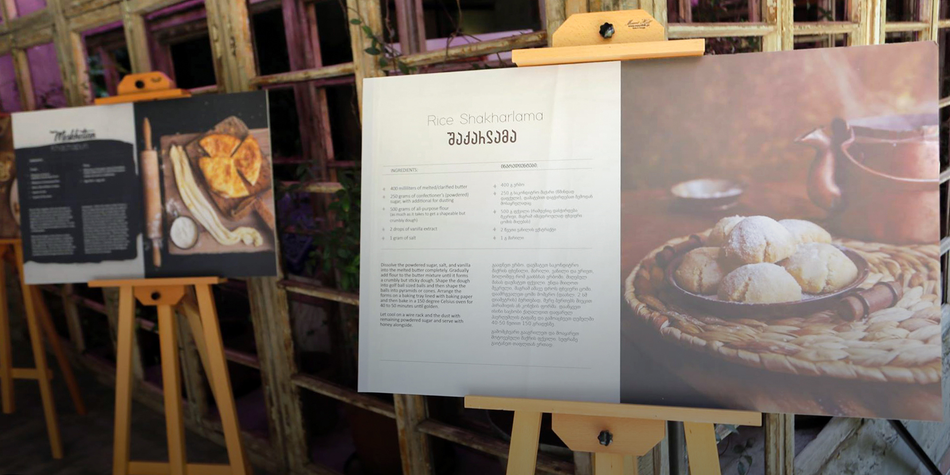 Two large printouts of recipes sitting on wooden easels. The closest one is titled 