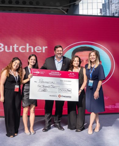 Image of four women posing with Jamey Butcher, President and CEO of Chemonics. They are holding a large check made out for $5,000.