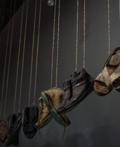 Photograph taken at the exhibition "Huellas de la Memoria," where 220 pairs of hanging shoes and footprints engraved with the names of missing people speaks of disappearances in a country with more than 73,000 cases.