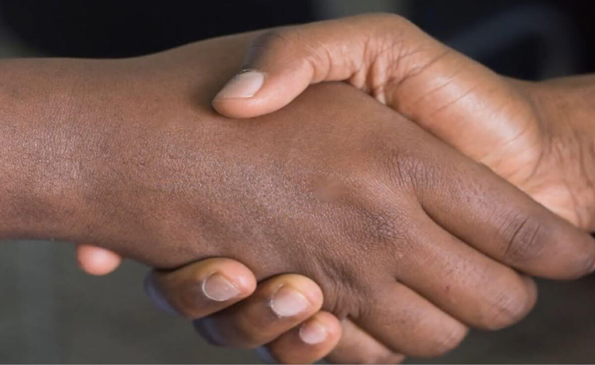 A close-up image of two people shaking hands.