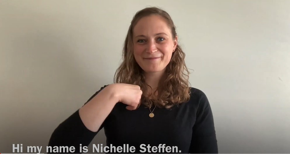 Image of a woman smiling with closed captioning that reads "Hi my name is Nichelle Steffen."
