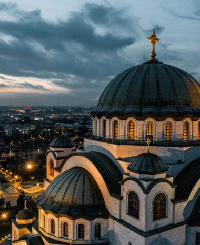 An aerial view of the Temple of St. Sava in Belgrade, Serbia at dusk.