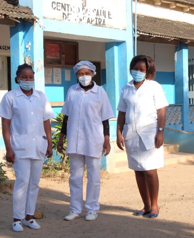 Three healthcare workers posing for a photo outside of a clinic.