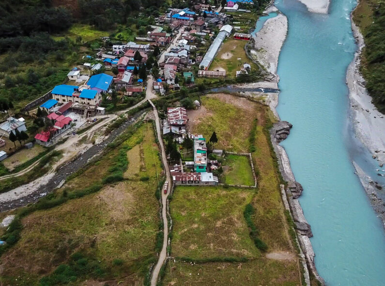 Overhead image of a Nepalese community situated next to a river.
