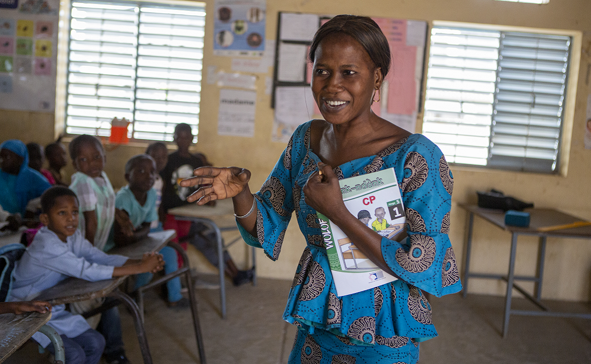Teacher in Senegal speaking to her students in a classroom.