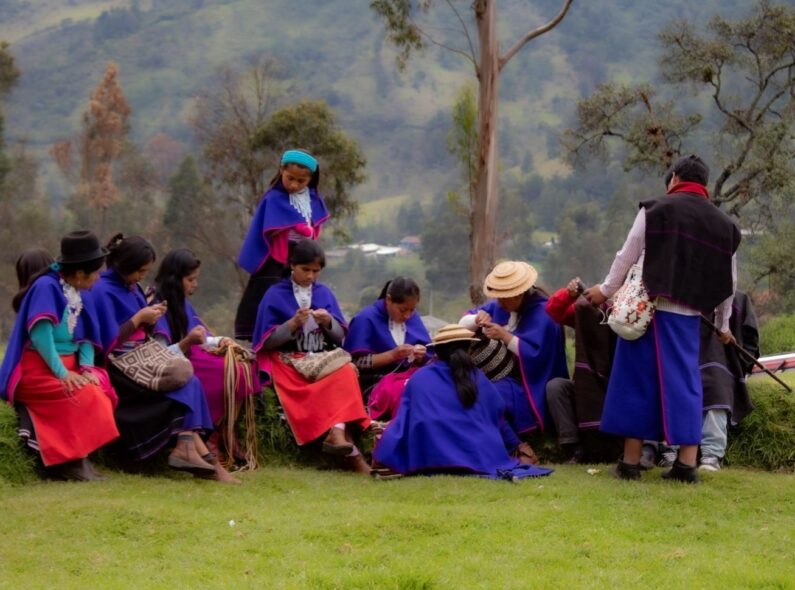 Group of women work on crafts in a field in Colombia