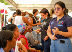 A Colombian government representative speaks to migrants at a service fair.