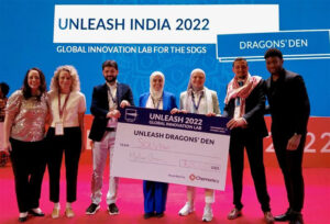 Chemonics representatives at UNLEASH India 2022 present a $25,000 cheque to the winning members of the SOLVillion's team.