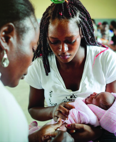 health worker vaccinating a baby