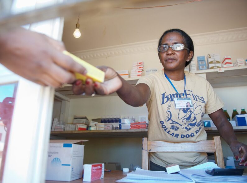Mada, a pharmacist in Madagascar, hands over a box of medicines to a patient. Credit: Lan Andrian for GHSC-PSM (2017)
