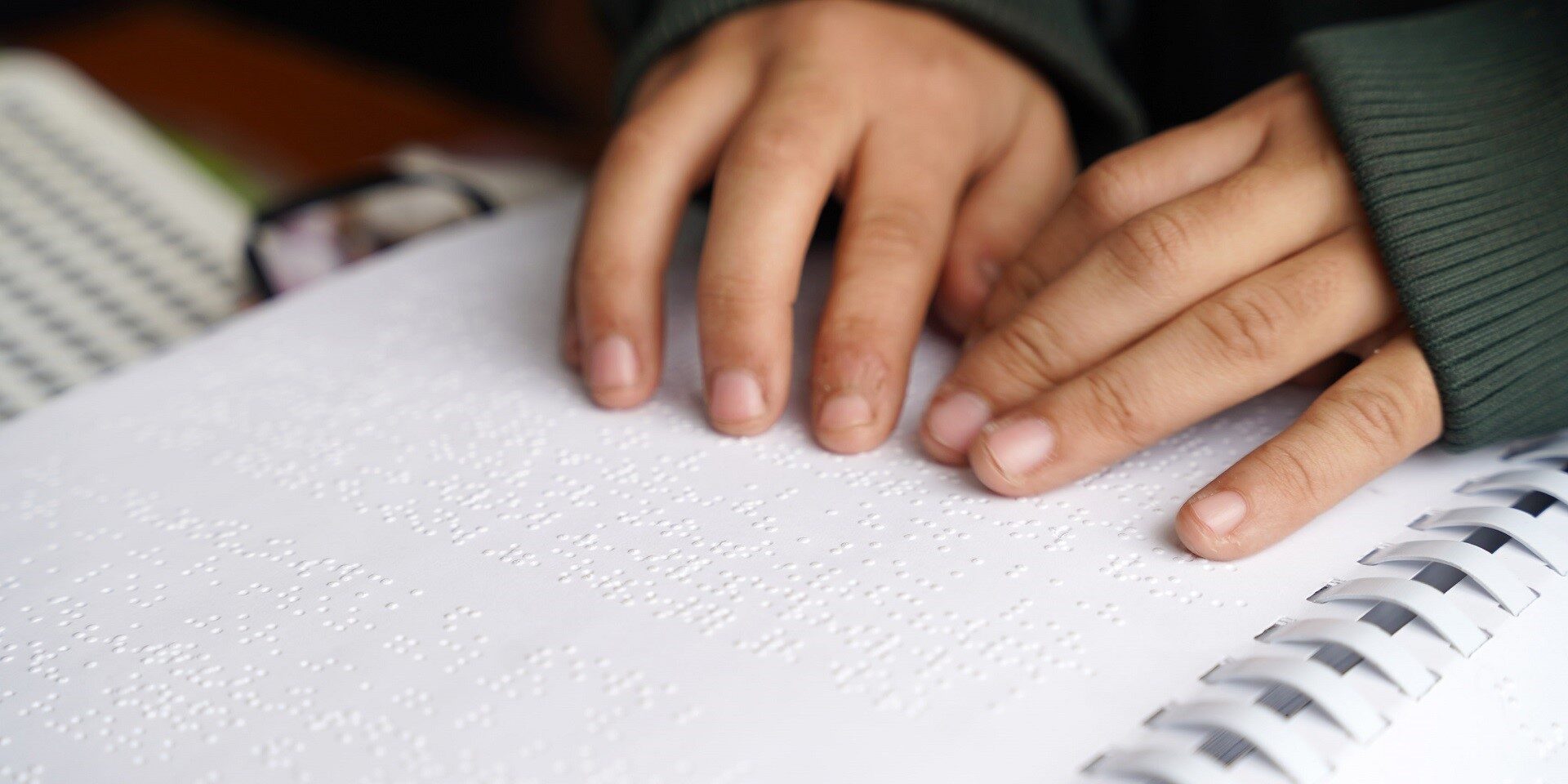Child's hands on Braille