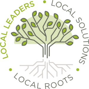 A tree grows from roots in the ground. The circle around it reads Local Roots, Local Leaders, Local Solutions.