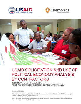 Cover page of a report featuring a photo of 5 people looking at a poster in front of them.