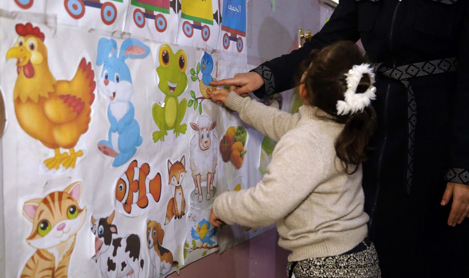 Lily learning with pictures of animals at the Manahel-supported special education centre