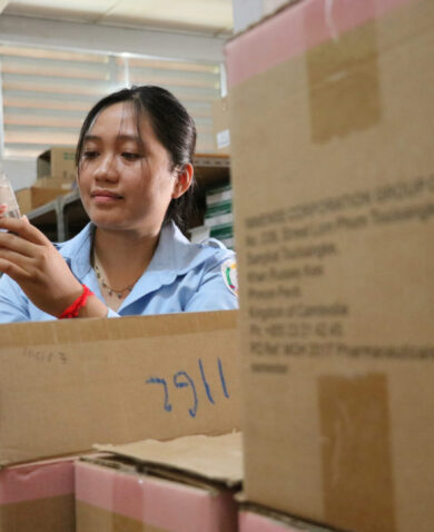 A woman inspects products at the Siem Reap warehouse facility in Cambodia