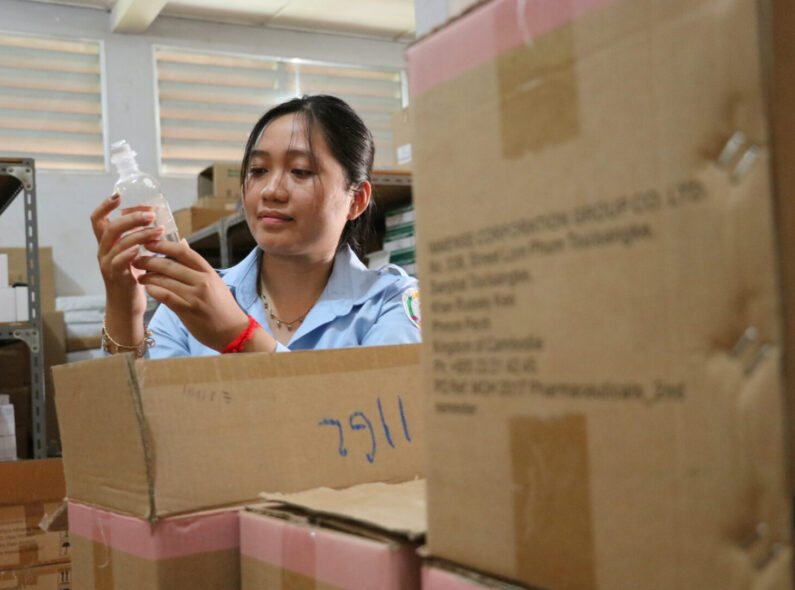 A woman inspects products at the Siem Reap warehouse facility in Cambodia