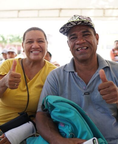 Two Participants at the Integrate Center in Cartagena, Colombia, face the camera and give a thumbs up.