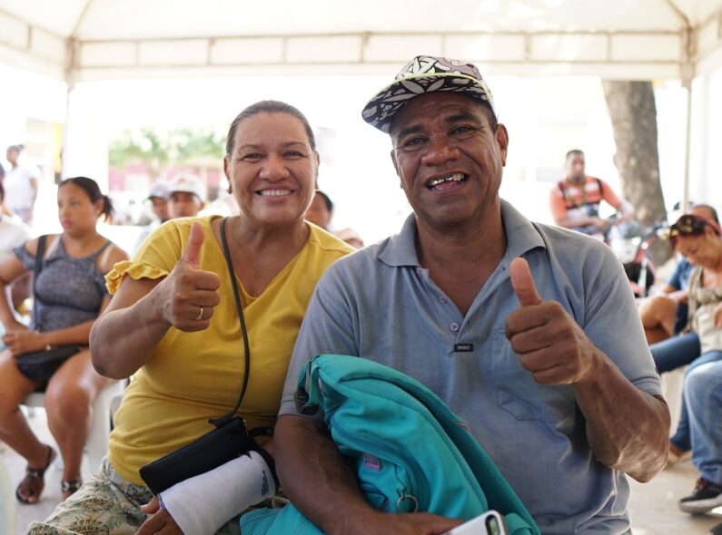 Two Participants at the Integrate Center in Cartagena, Colombia, face the camera and give a thumbs up.