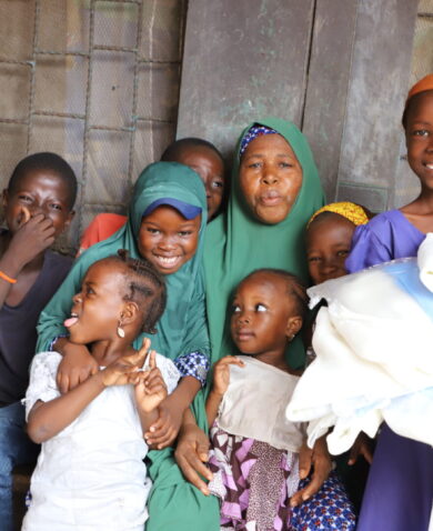A woman with her children smile after receiving ITN