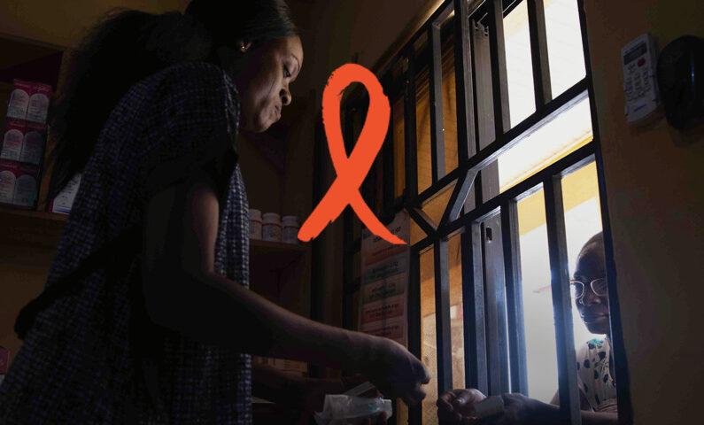 The red ribbon used to commemorate World AIDS Day is in for o a photo of a woman receiving medicines at a pharmacy.