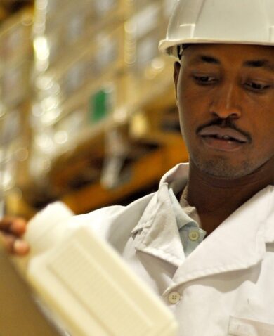 Warehouse employee Amos Mwangi packs medicine into a carton that will be delivered to a health facility.