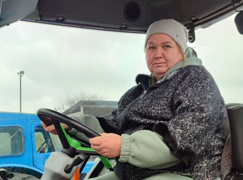 A woman sits in a tractor