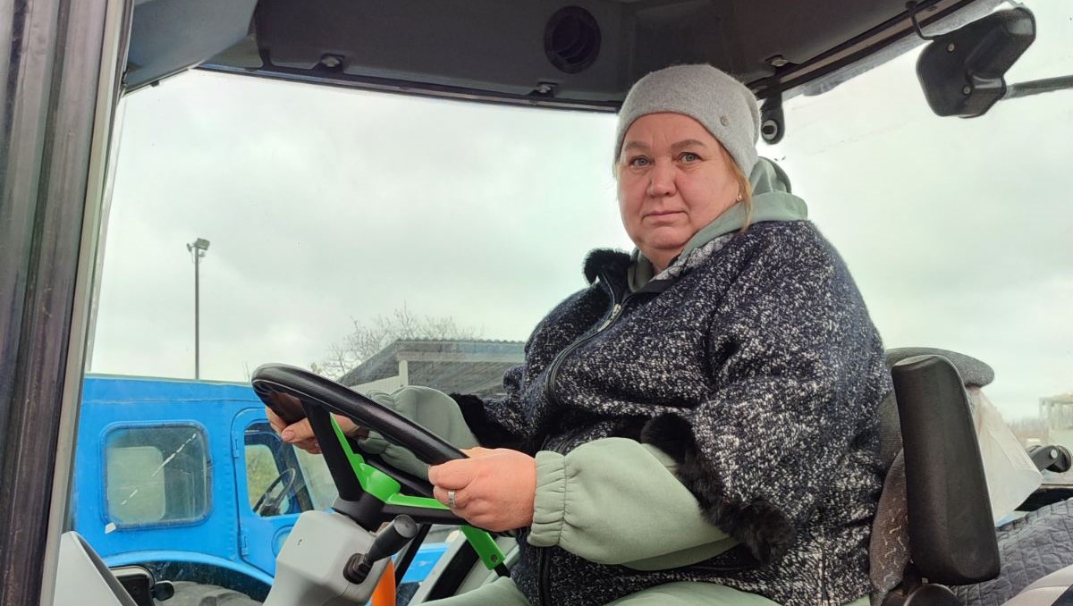 A woman sits in a tractor