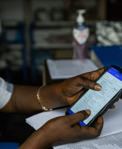 A health worker shows the device she uses to track commodities using InfoMED.