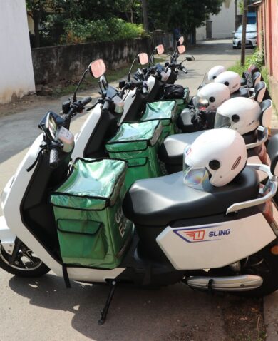 A row of electric 2-wheelers with white helmets