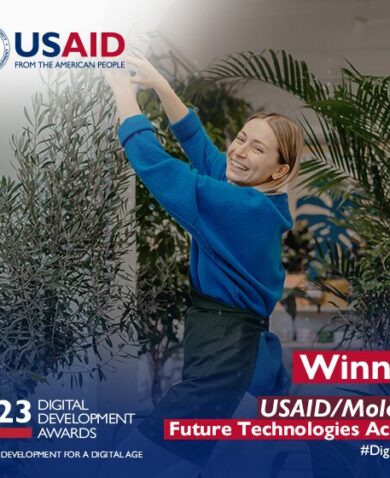 Woman tends to plants with USAID logo in the top corner, and winner with the project name in the bottom right corner