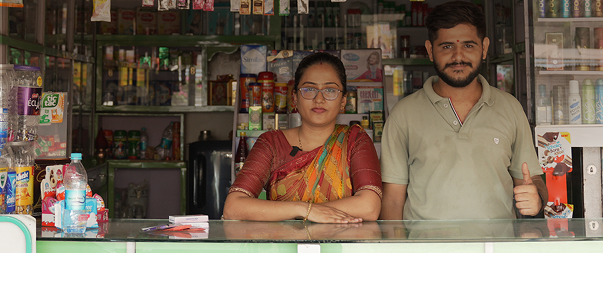 A man and a woman in front of a shop