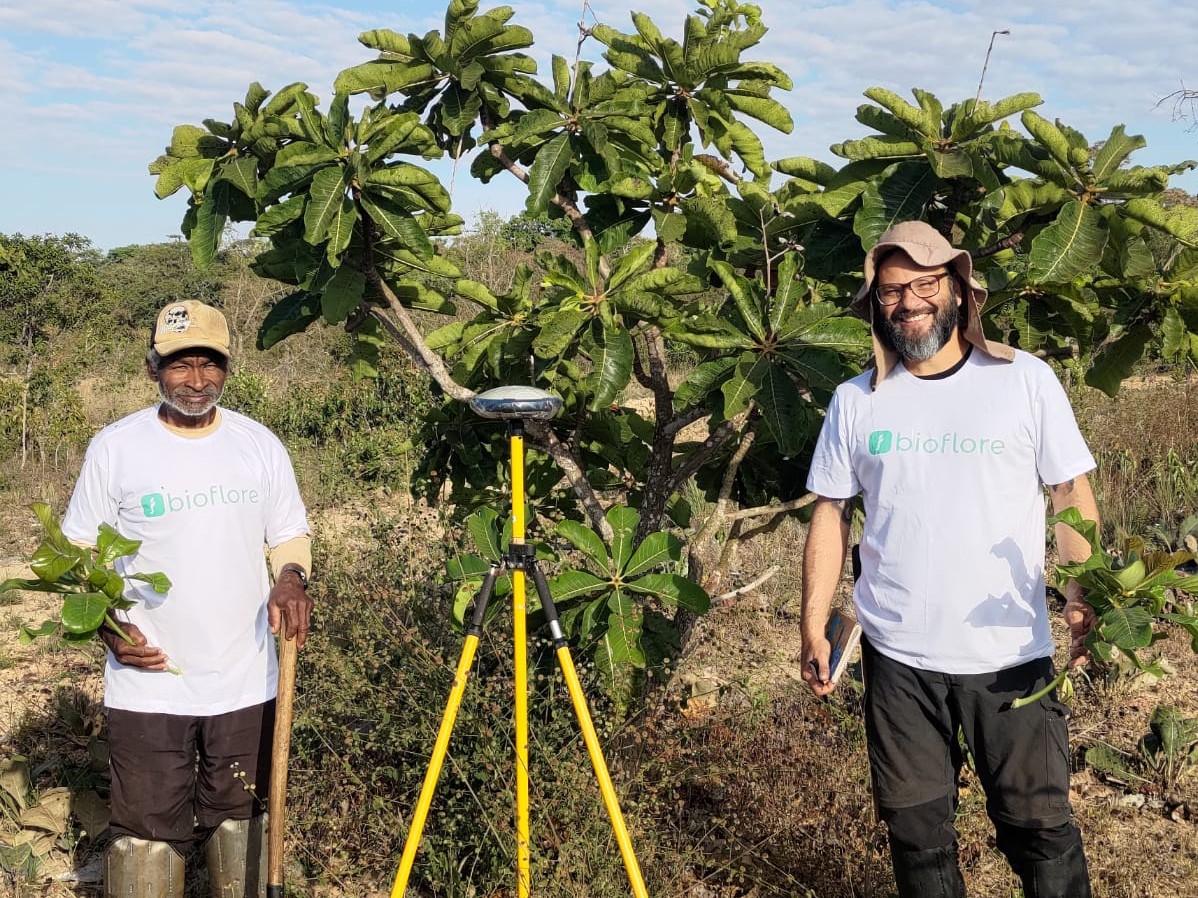 A forest steward and biologist stand in front of trees