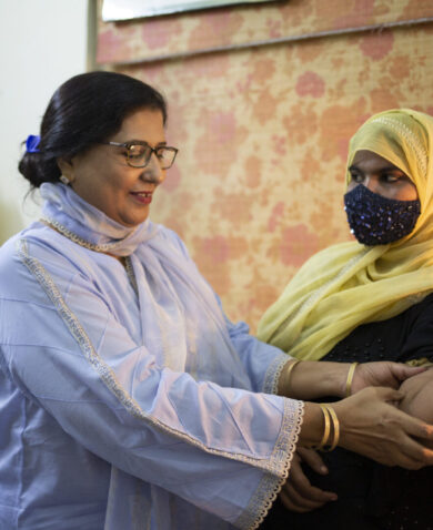 A doctor looks at a patient who has an implant for contraception at a health center