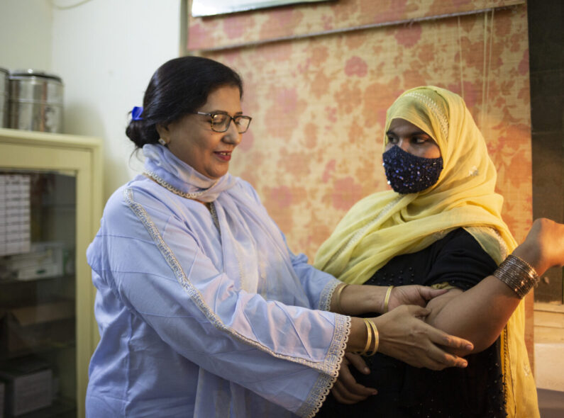 A doctor looks at a patient who has an implant for contraception at a health center